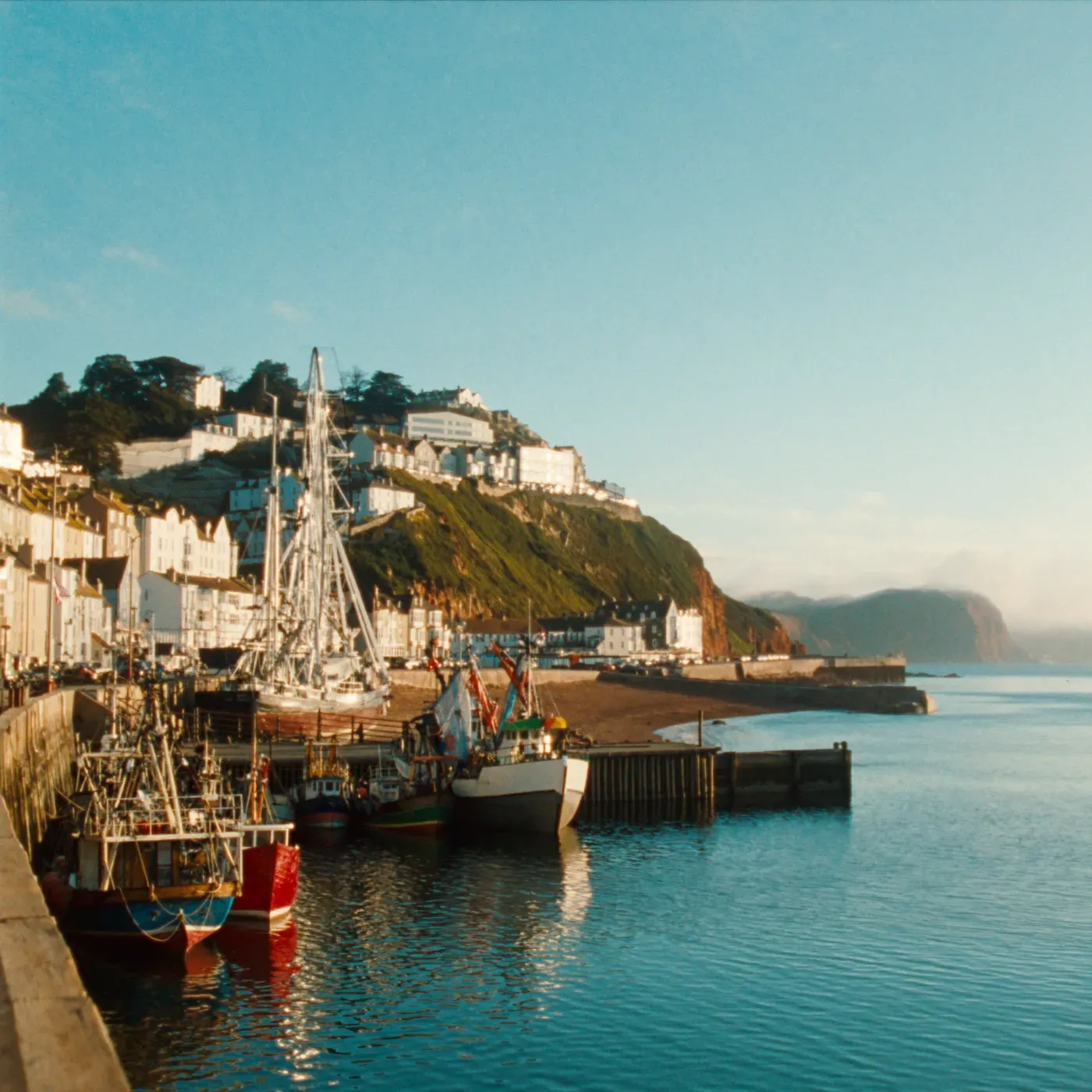 Illustrated coastal scene evoking United Kingdom, home of Rockfish Tinned Seafood