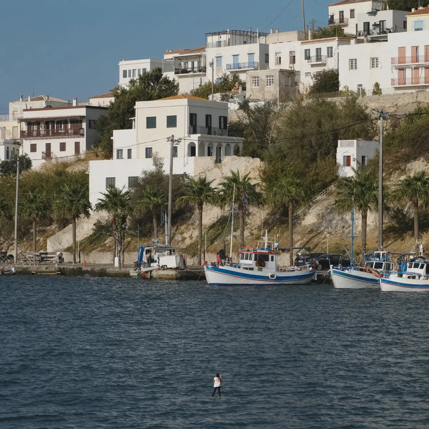 Illustrated coastal scene evoking Greece, home of th!nkgreen Natural Goods